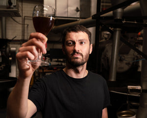 HOLDING UP A GLASS TO WINE FOR SHARING SOME KNOW-HOW WITH COFFEE